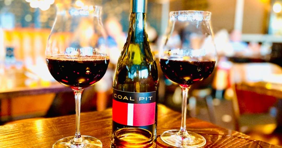 Bottle of Coal Pit wine plus two glasses  in  wine regions of the world - New Zealand