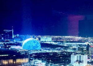 Night view of illuminated cityscape with glowing dome