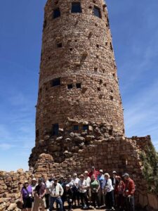 Group in front of historic stone tower.