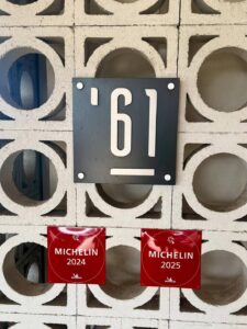 Michelin awards 2024-2025 displayed on wall.