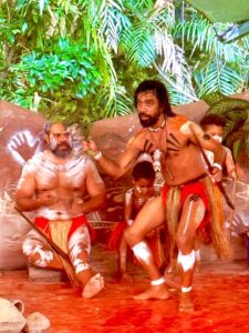 Indigenous dancers performing traditional ritual with body paint.