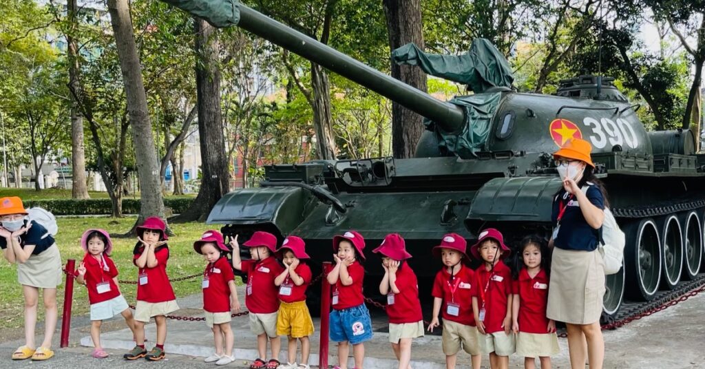 Best time to visit vietnam - Young schoolchildren in front of tank. 
