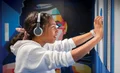 Girl wearing headphones in interactive exhibit