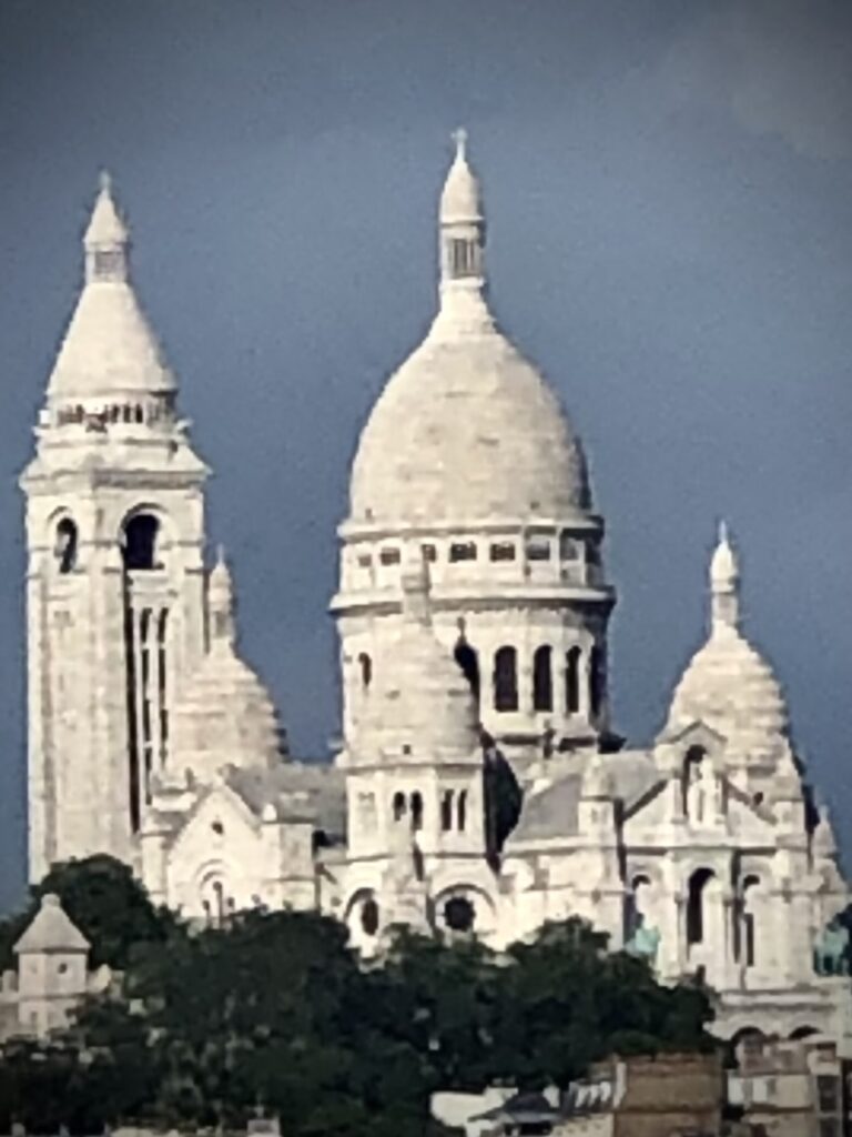 Sacre-Coeur Basilica in Paris under cloudy sky