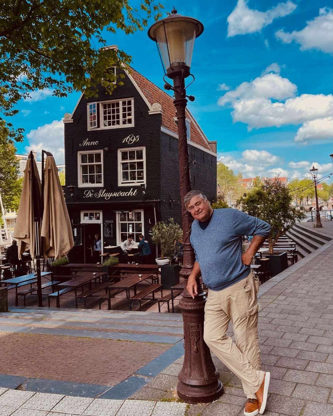Cos in front of a Pub, his favorite. How long is a flight from Atlanta to Amsterdam?