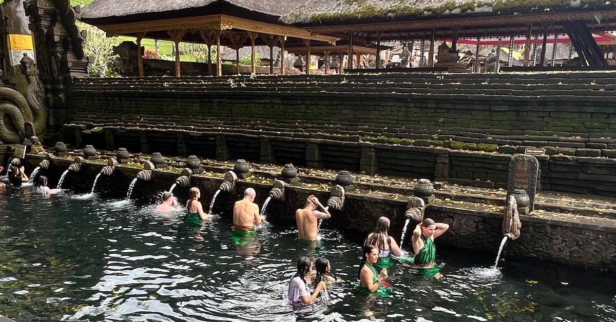 Bali 7 day Itinerary: Water Palace, people bathing in spiritual water