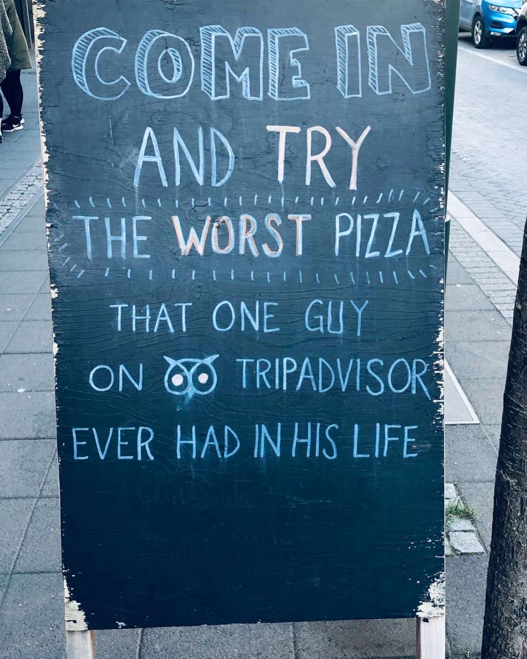 Sign in from of restaurant, sarcastically referring to a negative TripAdvisor review.