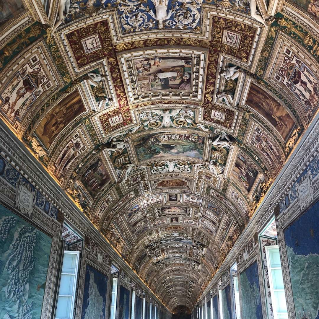 A highly decorated curved ceiling in a hallway at the Vatican in Rome