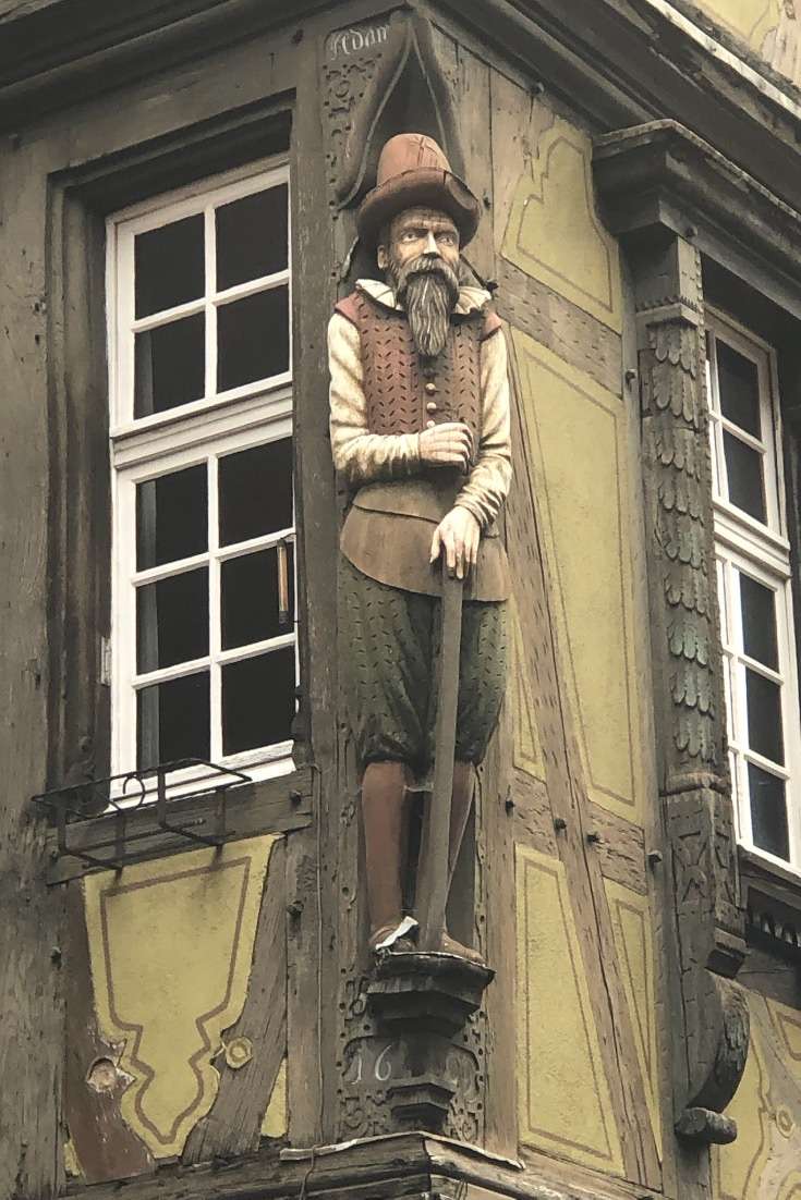 planning a trip to France- Colmar statue on the corner of a building