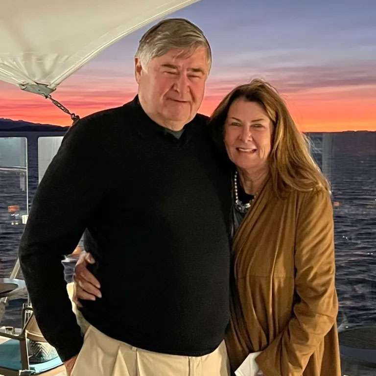 Couple embracing on boat at sunset