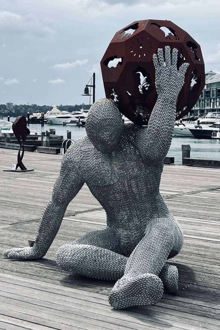 Statue of man holding globe