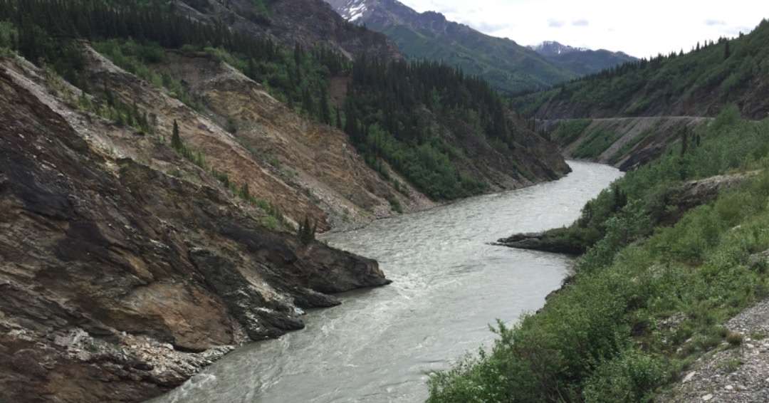 Curvy river next to train tracks