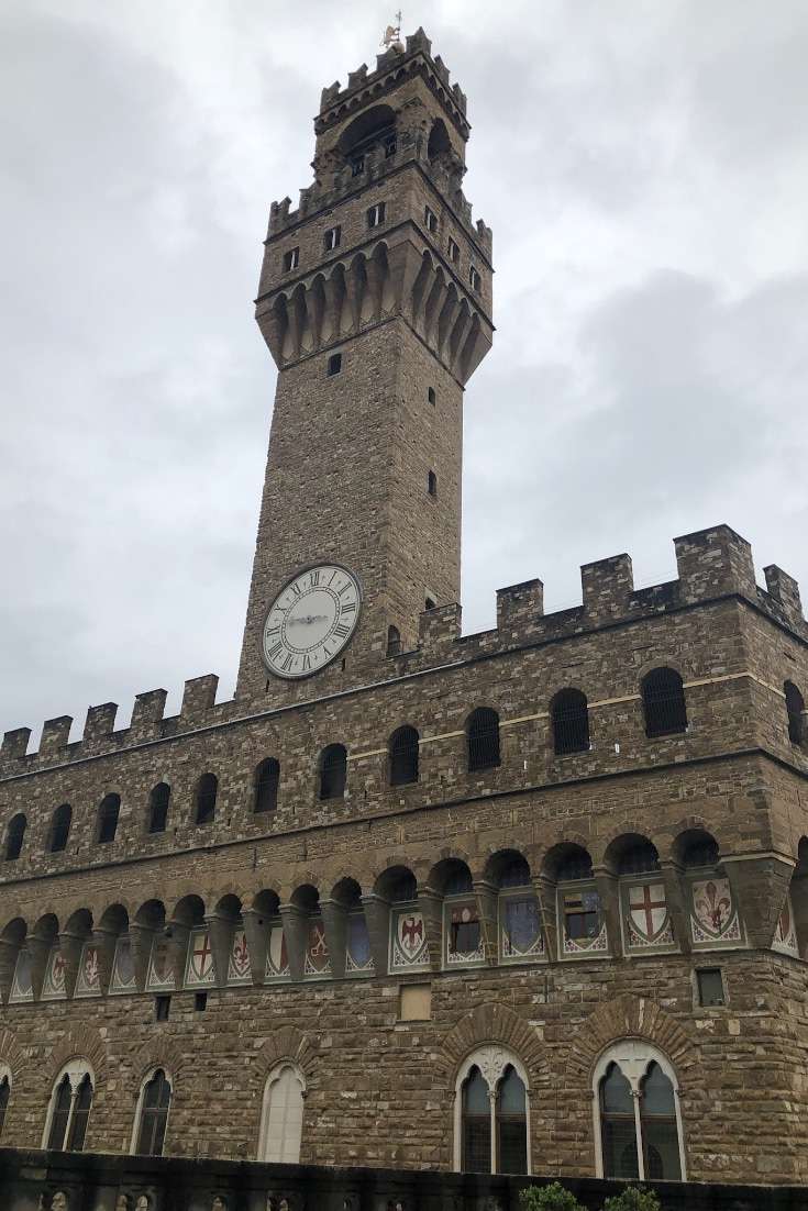 Large building with tower with clock showing 2:45 at the UIffizi in Florence