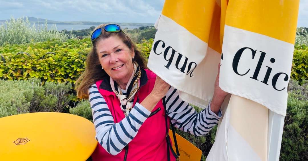 Robin holding up an umbrella, labeled with her favorite Champagne