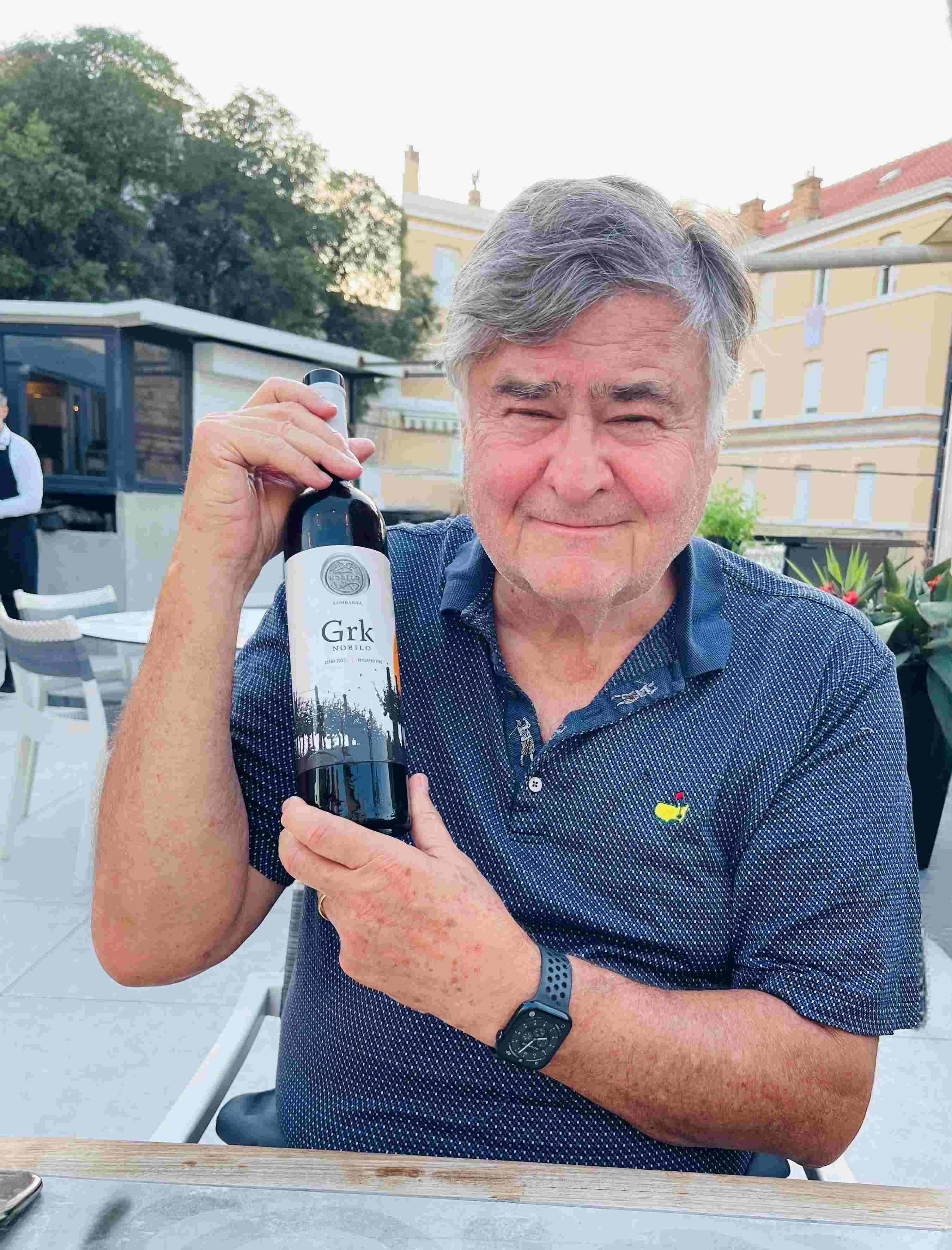 Paul holding a bottle of red wine, Grk, from Korcula, Croatia