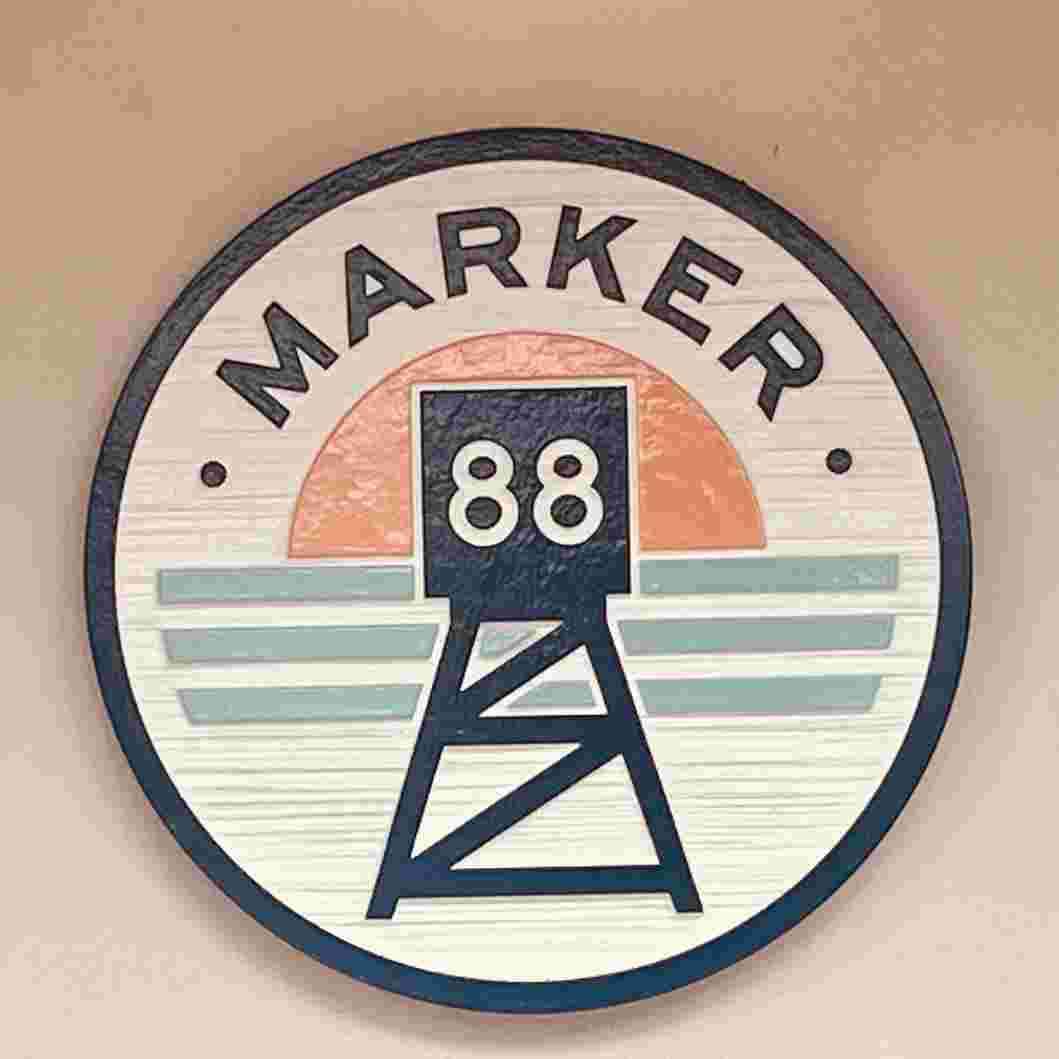 Market 88 sign with the setting sun and stylized water marks the site of the restaurant on the way to Key West