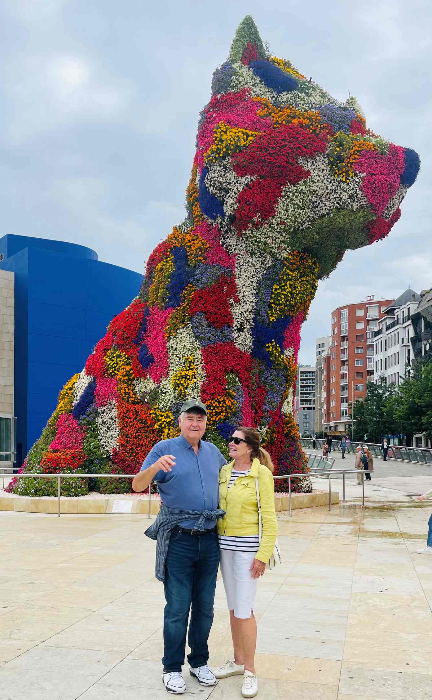 Paul and Robin in front of a large dog made of flowers in front of the Guggenheim Museum in Bilbao