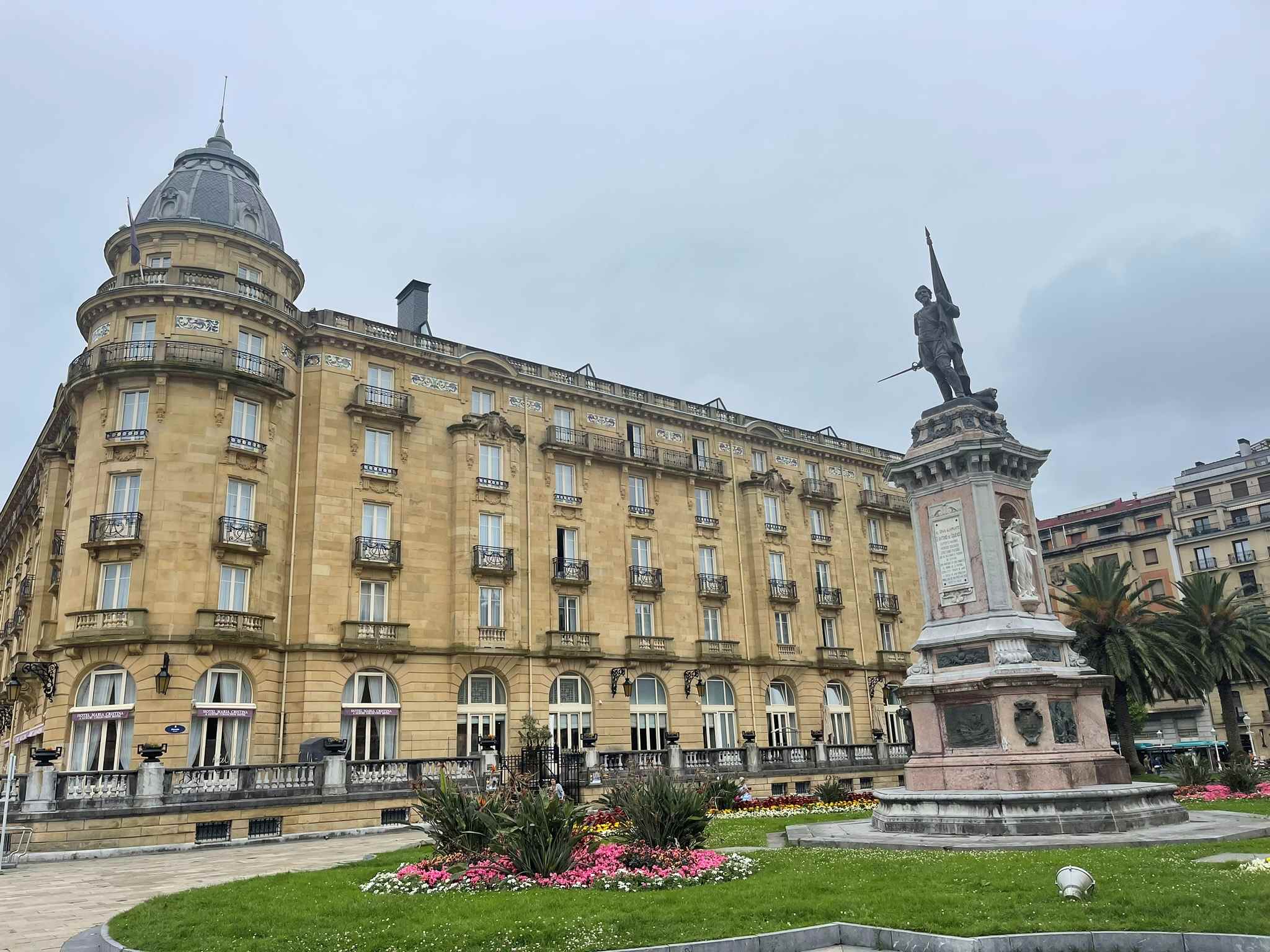 Large tan building with statue in front at San Sebastian, Northern Spain