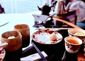 traveling to Hong Kong: Dim sum meal with tea on a table.