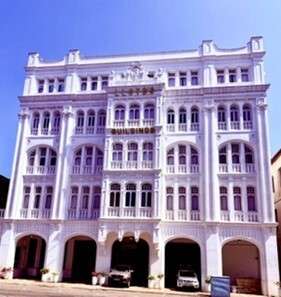 Historic white building with arched windows and balconies. Colombo Harbor Sri Lanka