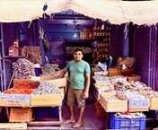 Man standing in dried goods store. Best Places to Visit in Sri Lanka