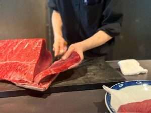 chef slicing tuna; ; Is Tokyo Expensive to visit? No