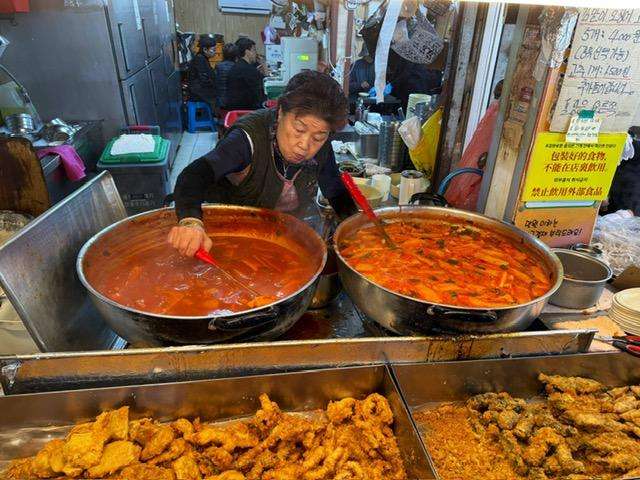 woman at the market cooking up a storm