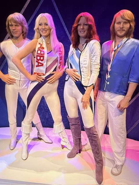 Four mannequins in classic 70s disco outfits.