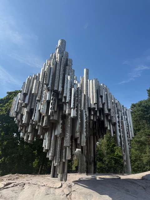 Sibelius Monument sculpture against blue sky in park.