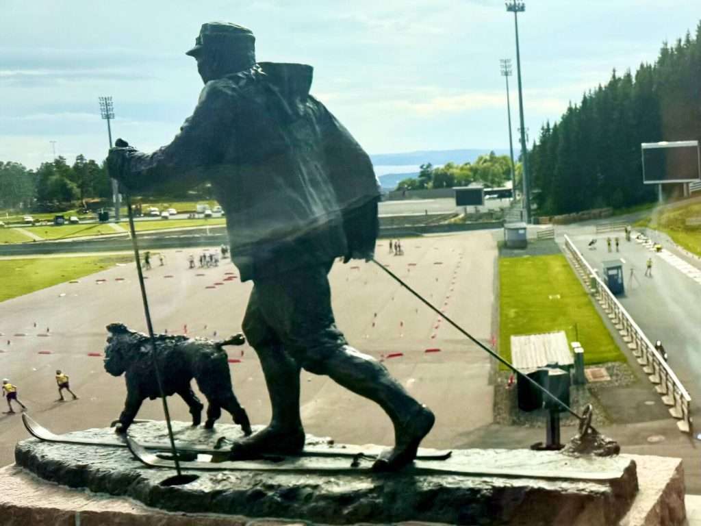 Statue of man skiing with dog
