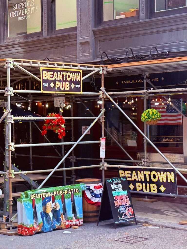 Beantown Pub entrance with outdoor seating and sign.