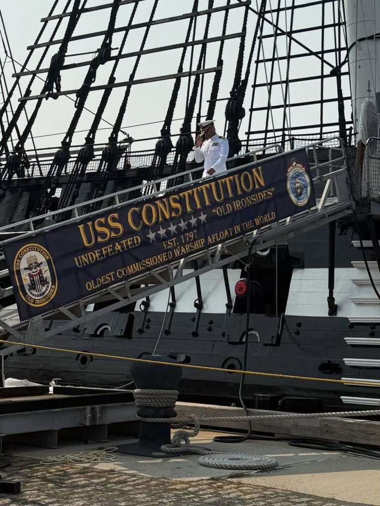 Sailor salutes on USS Constitution ramp.