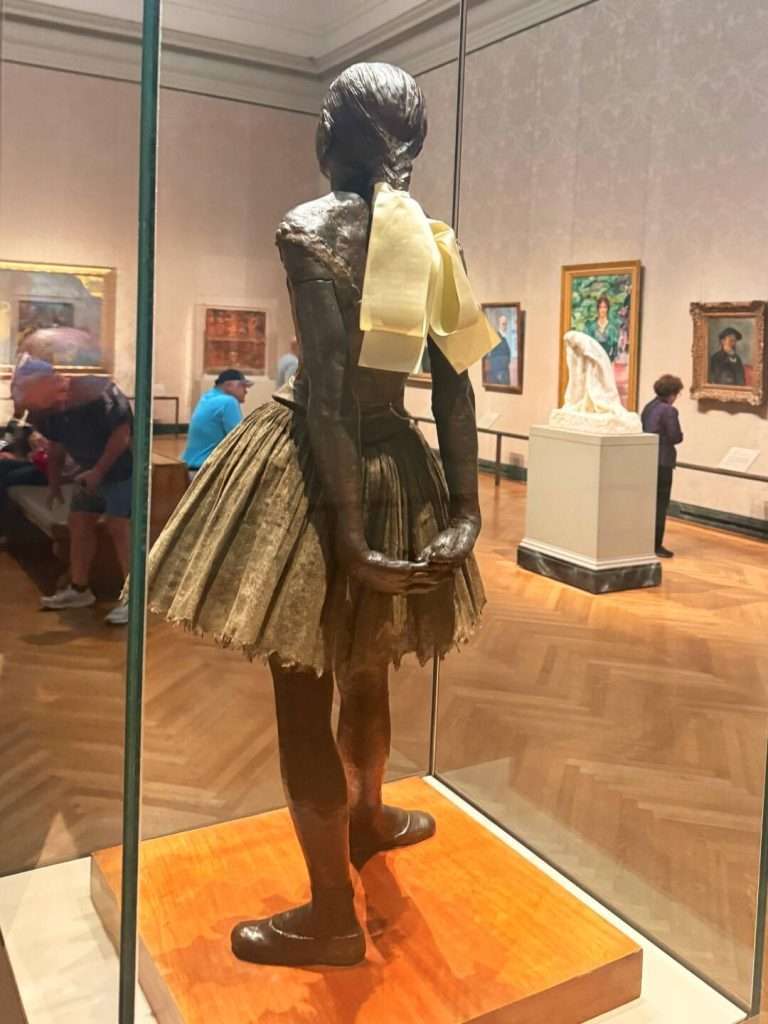 Bronze ballerina sculpture in museum gallery