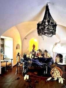 Haunted dining room with cobwebs and candles.
