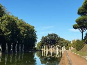 Scenic view of ancient ruins by reflecting pool.