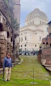 Person near ancient building with dome in Rome