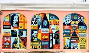 Colorful mural depicting Bermudian historical events and figures.