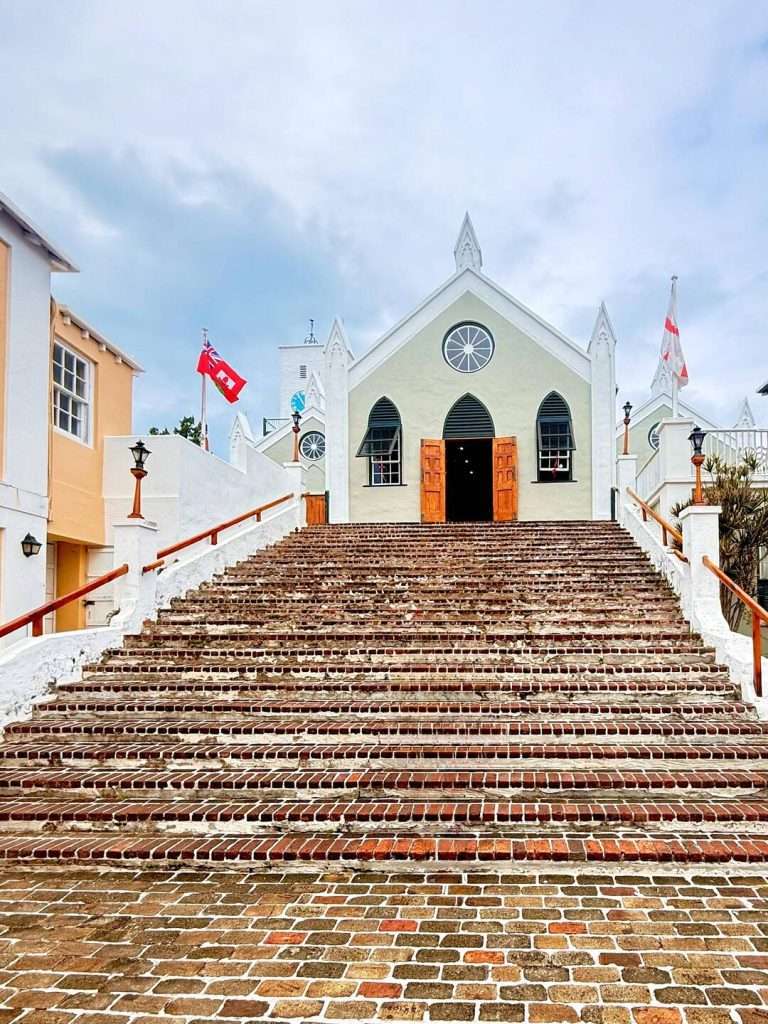 Historic church with large staircase and flags