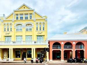 Yellow building with scooters parked outside.
