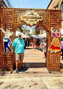 Entrance to outdoor market with festive decorations.