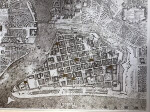 Historical city map with river and buildings.