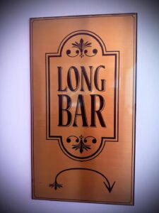 Decorative 'Long Bar' sign on a wall.