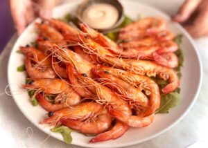 Plate of fresh shrimp with sauce.