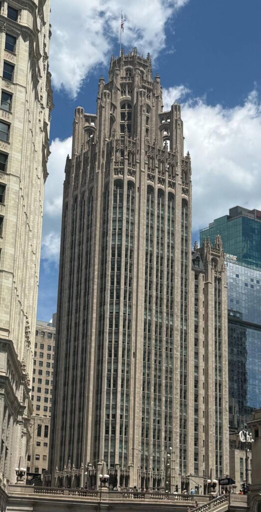 Historic Gothic skyscraper under blue sky.