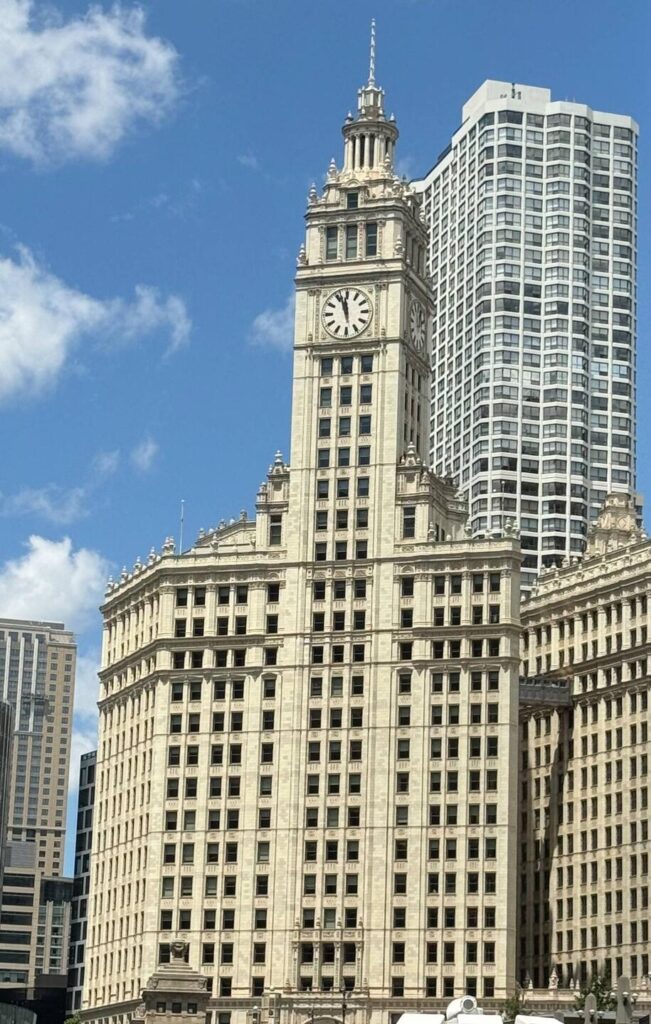 Historic skyscraper with clock tower in sunny Chicago.