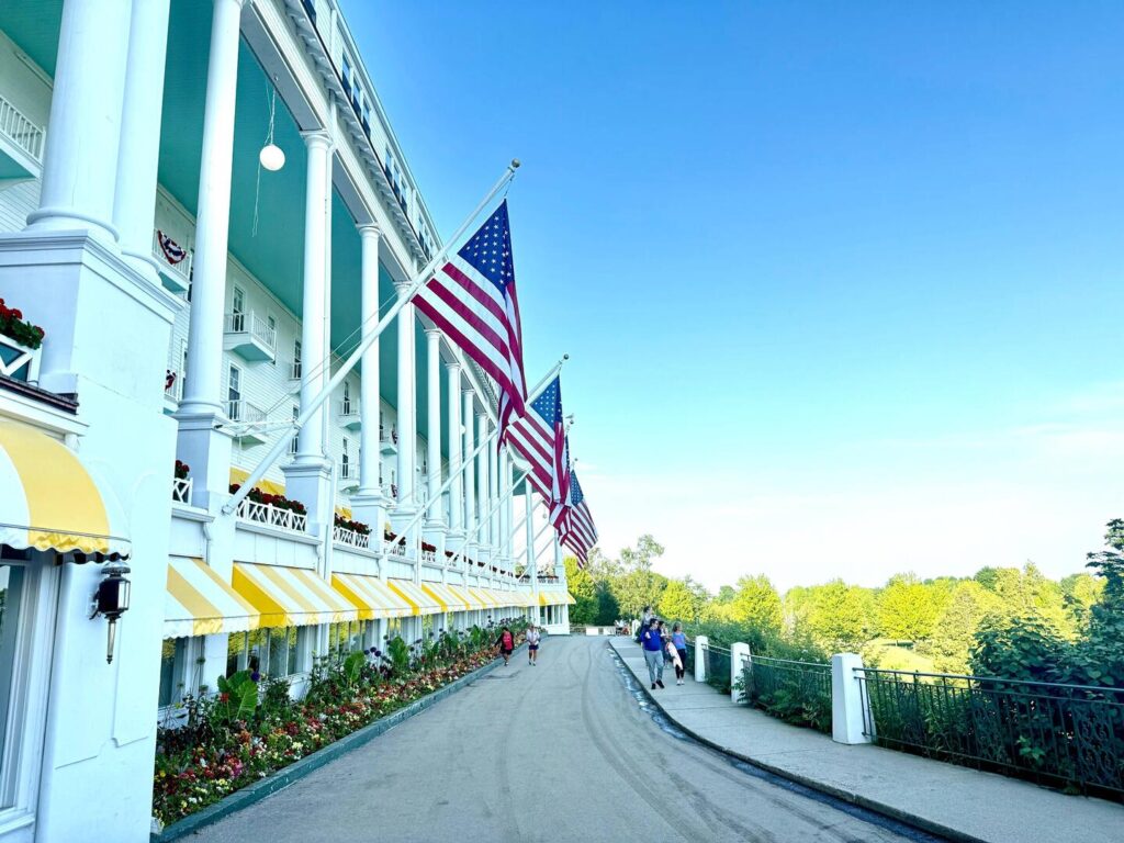 Large white building with American flags and yellow awnings.
