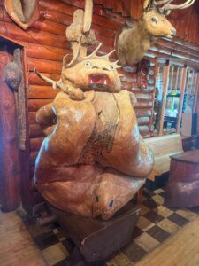 Unique wooden sculpture in rustic cabin setting.
