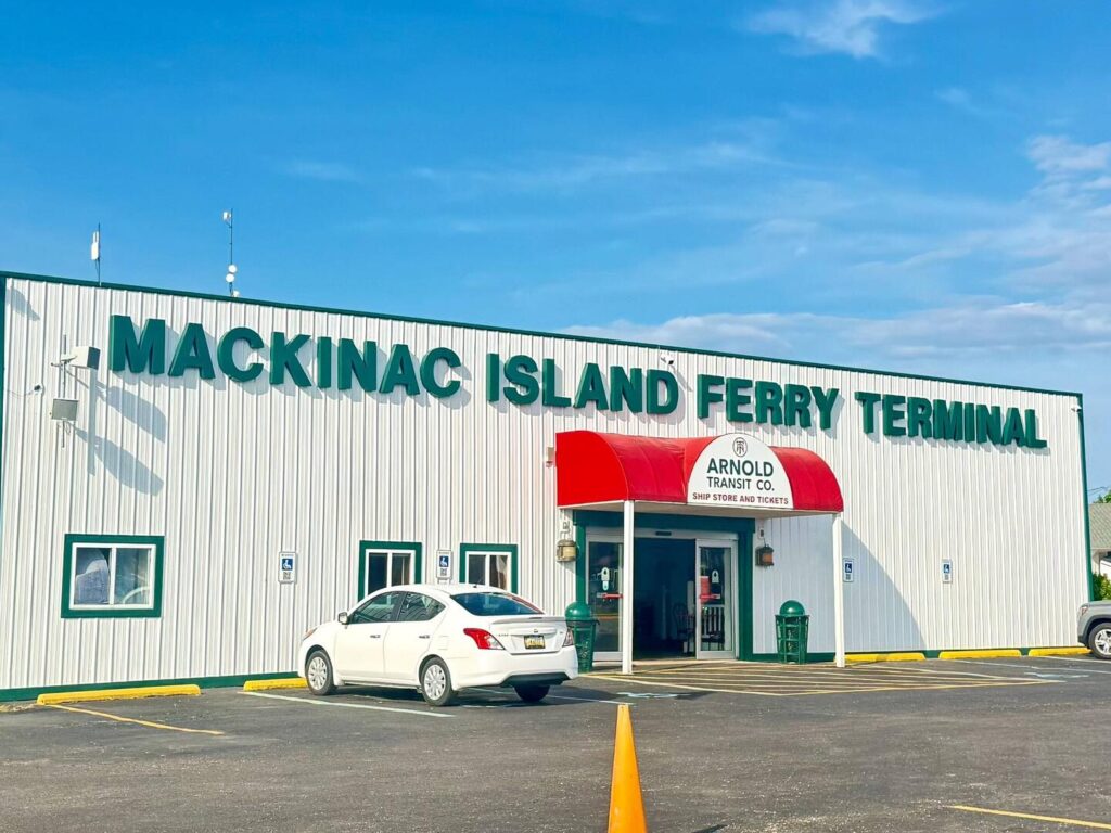 Mackinac Island Ferry Terminal entrance with parked car.
