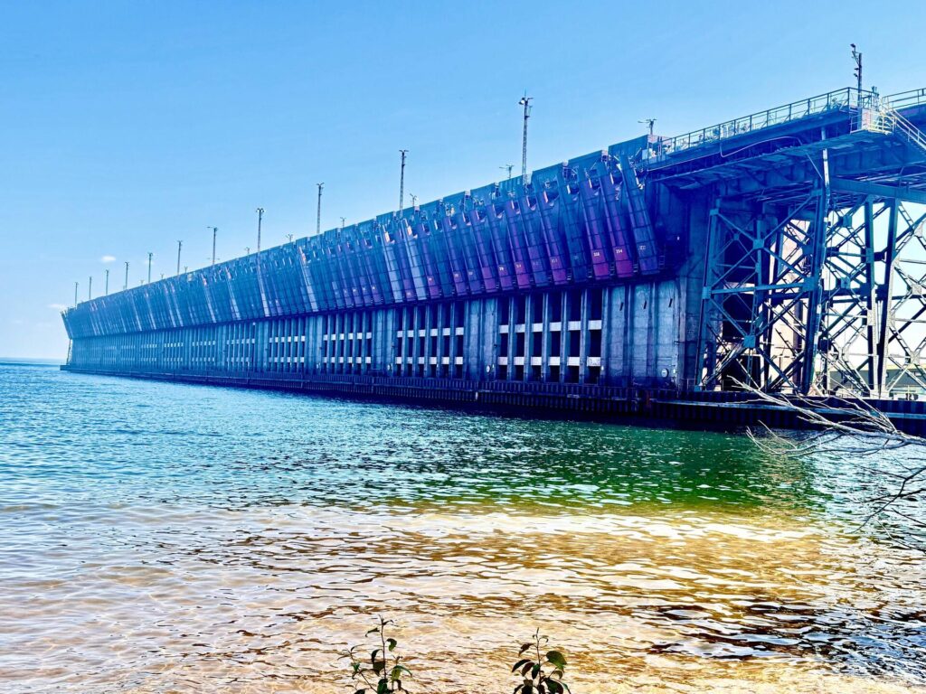 Industrial waterfront structure by clear blue lake.