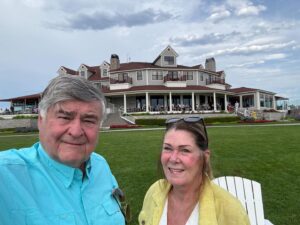 Couple smiling at scenic resort hotel background.